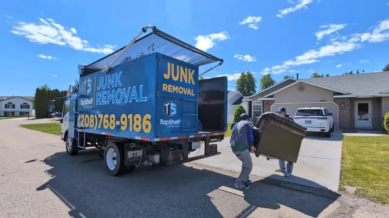Junk removal crew picking up a couch in a Boise neighborhood